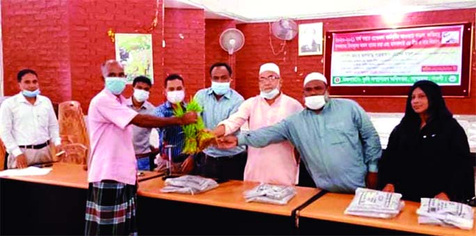 Shahjahan Hossain Mondol, Chairman of Sapahar upazila Parishad in Naogaon district distributes paddy saplings, mash seeds and fertilizers among the farmers free of cost in the upazila Parishad Auditirium on Wednesday. UNO Kalyan Chowdhury was also present