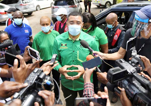 Jamaica's Prime Minister Andrew Holness talks to the media before casting his vote in the general elections, in Kingston, Jamaica on Thursday.