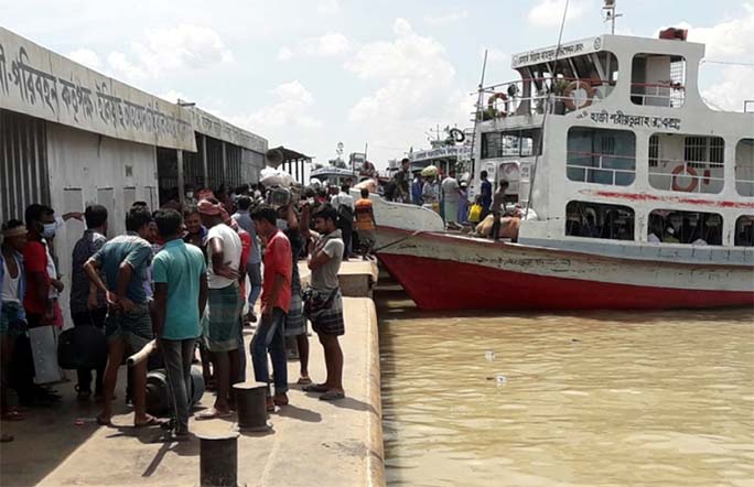 Passengers remain in stranded as the ferry services were suspended due to strong current at Kathalbari-Shimulia Ferryghat on Friday.