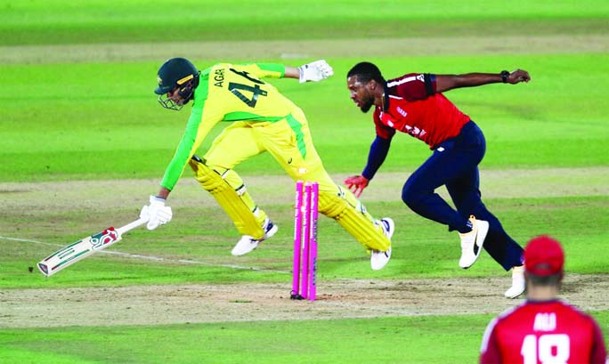 England's Chris Jordan (right) gets a direct hit on the stumps to run out Australia's Ashton Agar during their first T20I match at the Ageas Bowl in Southampton on Friday.