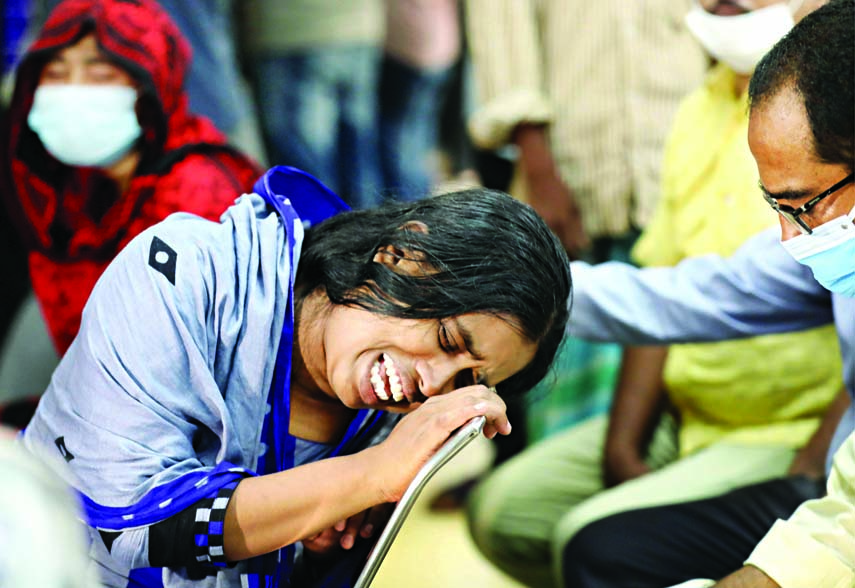 A woman mourns the death of a relative outside Dhaka Medical College Hospital on Saturday after a suspected gas explosion sent flames raging through a mosque in Narayanganj killing at least 20 worshippers.