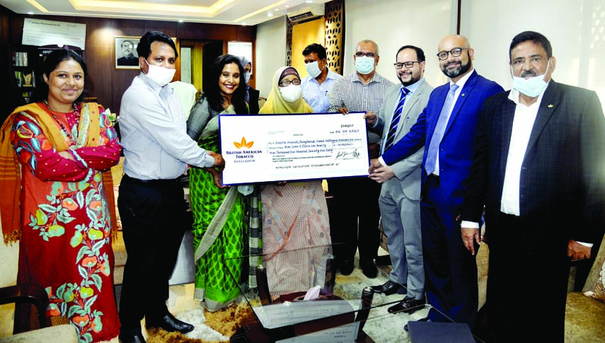 Head of Human Resources, Saad Jashim hands over a cheque to State Minister for Labour and Employment Begum Monnujan Sufian on behalf of British -American Tobacco for Bangladesh Sramik Kallyan Federation at the Ministry office on Sunday.- PID photo