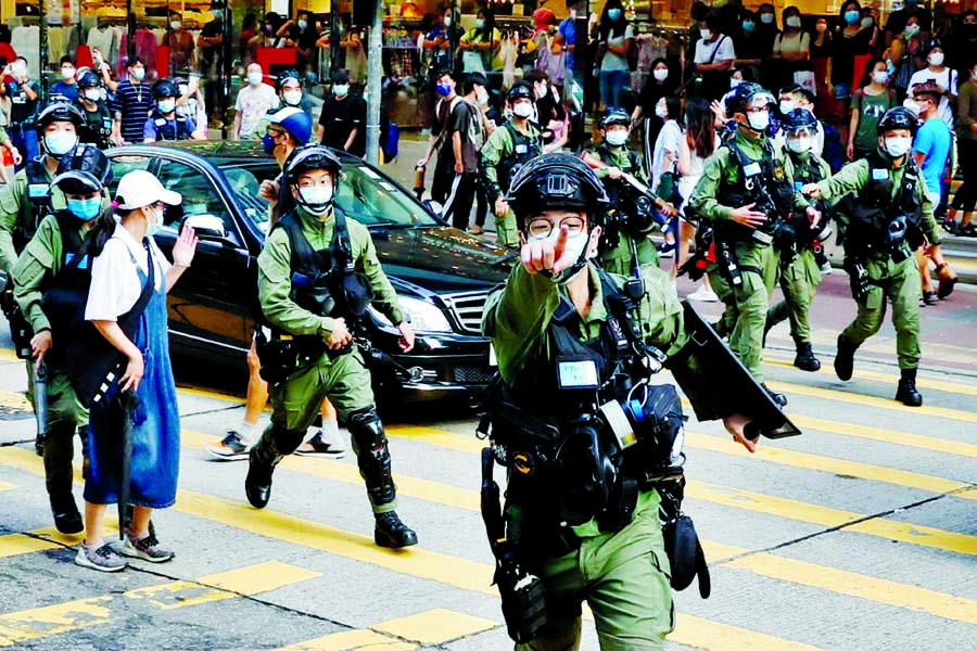 Riot police chase pro-democracy protesters during a demonstration oppose postponed elections, in Hong Kong, China on Sunday.