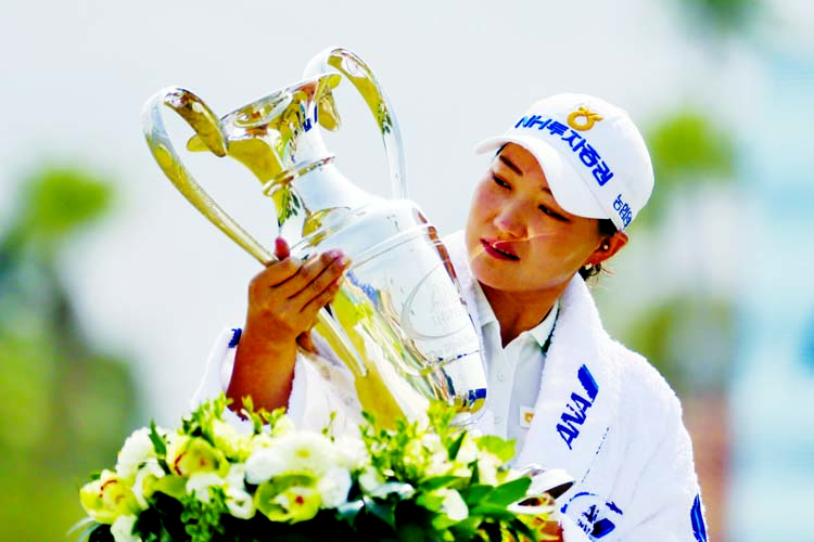 Mirim Lee, of South Korea, holds the championship trophy after winning the LPGA's ANA Inspiration golf tournament at Mission Hills Country Club in Rancho Mirage, California on Sunday.