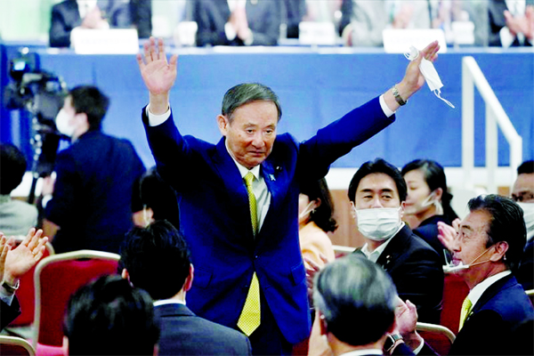 Japanese Chief Cabinet Secretary Yoshihide Suga gestures as he is elected as new head of the ruling party at the Liberal Democratic Party's (LDP) leadership election in Tokyo, Japan on Monday