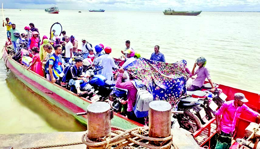 Ferrying people and two-wheelers by trawlers has become a lucrative business nowadays for some people following suspension of Shimulia-Kathalbari Riverine route due to poor navigability of the Padma river. This photo was taken from Shimulia Ghat on Monday
