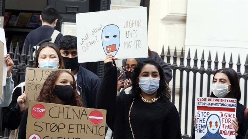 People take part in a demonstration against China's persecution of Uighurs in Xinjiang in front of the Chinese embassy in London.