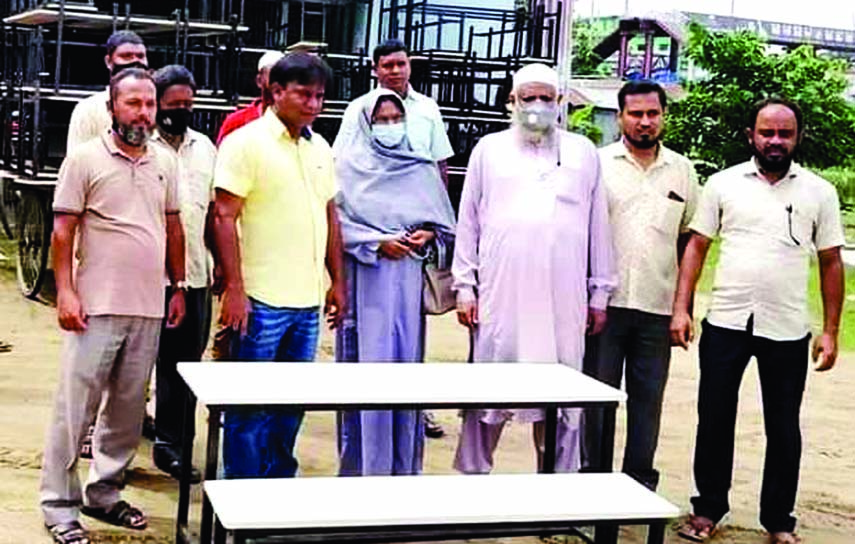 Natore's Singra Municipality Mayor Jannatul Ferdousi distributes benches to three schools in the Upazila at a ceremony recently.