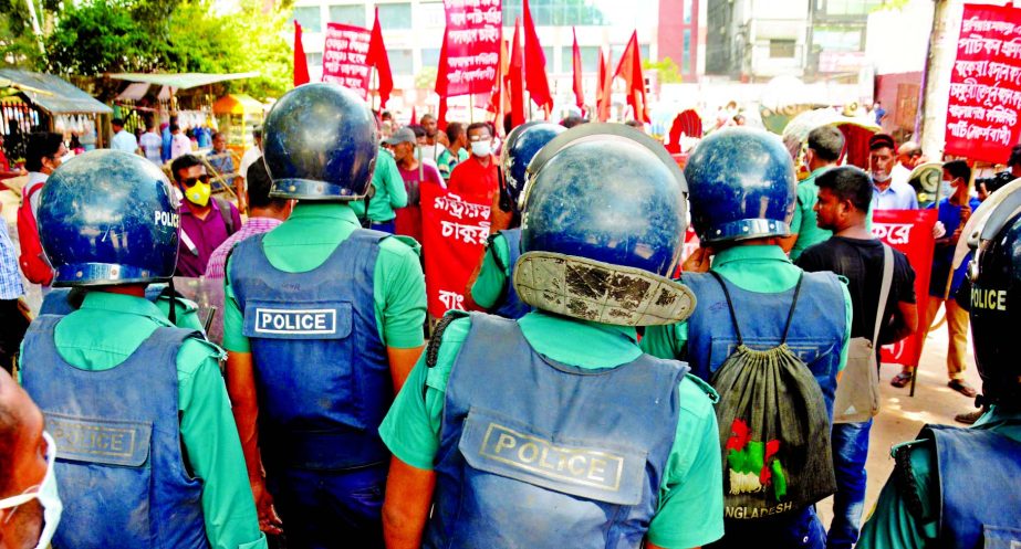 Police intercept procession of Bangladesh Communist Party near Jatiya Press Club on Tuesday when the party trying to proceed forward to beseige Ministry of Jute demanding immediate payment of arrear salaries of the mill workers and solve their other probl