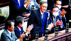 Yoshihide Suga is applauded after he was elected as Japan's Prime Minister by the lower house of the Diet in Tokyo on Wednesday.