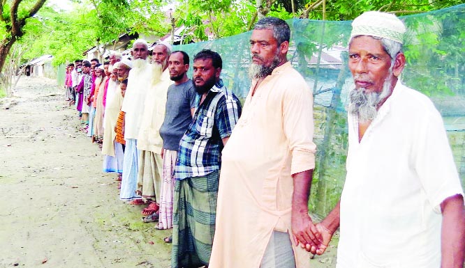 Locals form a human chain in front of Hogolpati Govt Primary Scholl at 11 No Nishanbaria Union in Morolganj upazila of Bagherhat district on Thursday demanding release of Madrasha student Sabbir Sheikh.