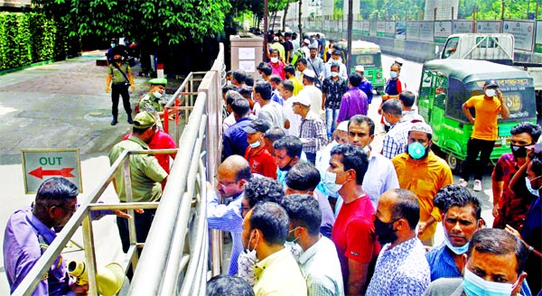 Expatriates, who have been stuck in the country due to the coronavirus lockdowns, crowd in front of the Saudi Airlines office at Hotel Sonargaon in the capital on Thursday to confirm their tickets to return to their workplaces.