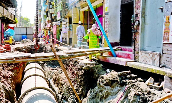 A big trench has been dug up for laying sewerage pipeline on Raj Narayan Road at Lalbagh in the capital causing huge inconvenience to local people. This snap was taken on Friday.