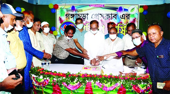 Upazila Chairman Ruhul Amin along with journalists cutting a cake to celebrate the 34th founding anniversary of the Gangachara Press Club on Saturday.