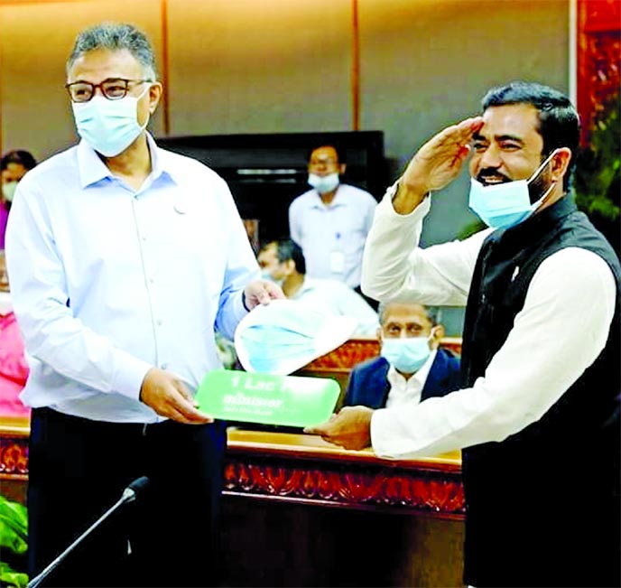 MA Razzak Khan Raj, Chairman of Minister-MyOne Group and Director of FBCCI, handing over a check and 1 lakh pieces of Minister Surgical Mask to Dr Ahmad Kaikaus, Principal Secretary of Prime Minister as donation for the Prime Minister's Relief and Welfar