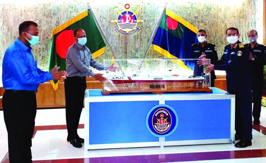 Director General of Bangladesh Coastguard Rear Admiral M Ashraful Haq hands over a model of Patrol Boat to Director General of National Museum of Science and Technology Munir Chowdhury for exhibition at the museum at a ceremony held on Monday at the Headq