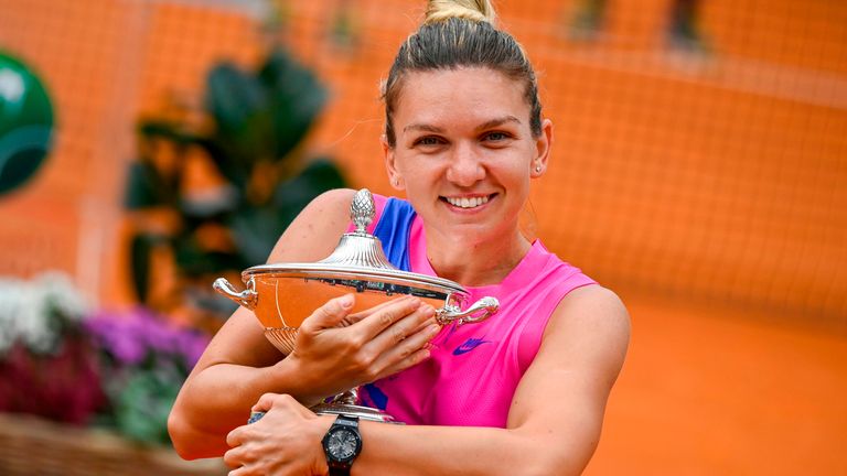 Romania's Simona Halep celebrates celebrates with the trophy after Czech Republic's Karolina Pliskova retired from the match after sustaining an injury in Rome on Monday.