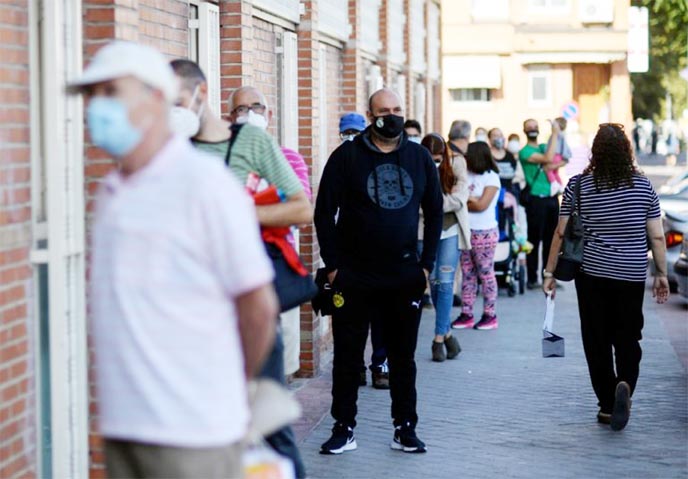 Residents queue to access the Cuzco healthcare centre in the under partial lockdown town of Fuenlabrada, in Madrid, Spain.