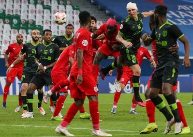 Al Taawoun's forward Mitchell Duke, with his head swathed in bandages, heads the ball during the AFC Champions League Group C match between Qatar's Al-Duhail and Saudi's Al-Taawoun at the Education City Stadium in the Qatari city of Ar-Rayyan on Thursd