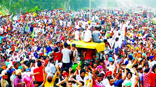 Farmers gesture as they block a national highway during a protest against farm bills passed by India's parliament, in Shambhu in the northern state of Punjab, India on Friday.