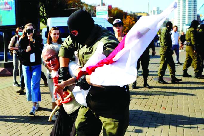 A Belarusian law enforcement officer detains activist Nina Baginskaya during an opposition rally to reject the presidential election results and to protest against the inauguration of President Alexander Lukashenko in Minsk, Belarus on Saturday.