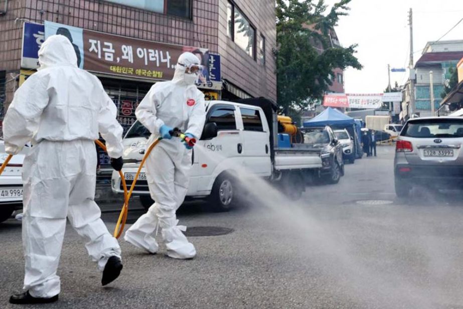 Health workers disinfect streets near Sarang Jeil Church in Seoul, South Korea.