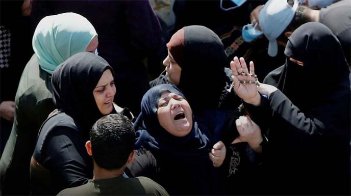 The mother of two Palestinian fishermen Hassan and Mahmoud al-Zazoua reacts during their funeral after their bodies were returned from Egypt, in the central Gaza Strip, on Sunday.