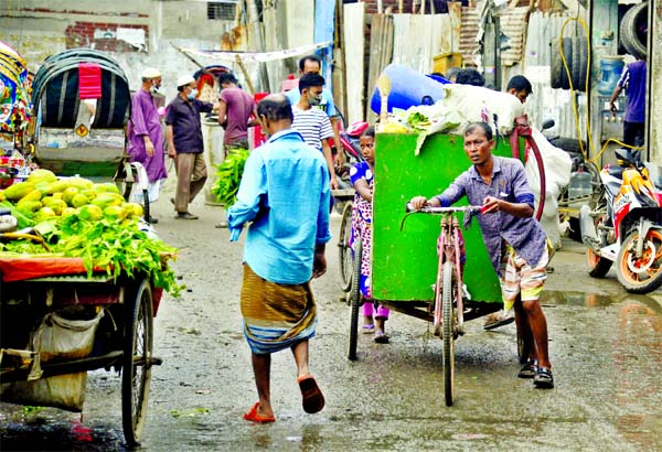 A man moves with his van at the Aga Sadek Road in Dhaka South City Corporation area collecting waste from houses on Sunday.