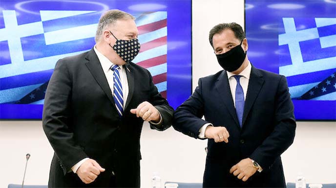 U.S. Secretary of State Mike Pompeo and Greek Minister for Development and Investment Adonis Georgiadis touch elbows during an agreement signing ceremony in Thessaloniki, Greece on Monday.