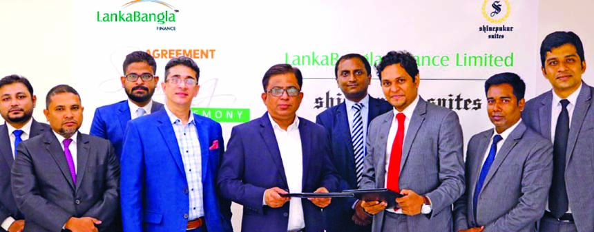 Khurshed Alam, Head of Retail Business of LankaBangla Finance Limited (LBFL) and Biswajit Saha, Head of Operation & Corporate Affairs of Shinepukur Suites, exchanging document after signing a MoU at LBFL head office in the city on Tuesday. Under the deal,