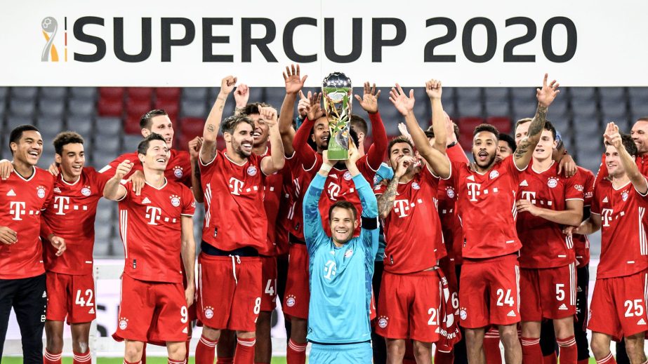 Bayern Munich's Manuel Neuer (with the trophy) and teammates celebrate with the trophy after winning the German Super Cup on Wednesday.