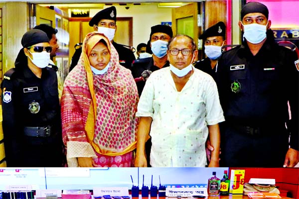 RAB personnel produce Md Imam Hossain Nasim, owner of Nasim Real Estate and his assistant Halima Akter Salma before media on Thursday after their arrest from capital's Rupnagar area for fraudulent activities.