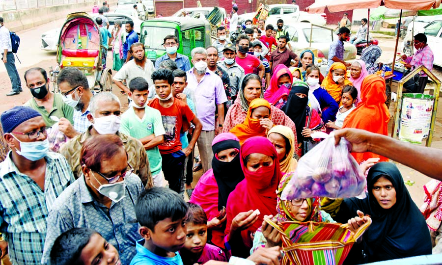 Buyers crowd in front of the TCB's mobile sales centre near the National Press Club in the capital on Thursday to buy commodities at subsidized rate.