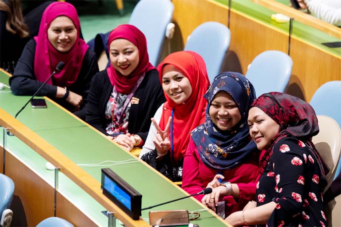 Women pose for a selfie during International Women's Day earlier this year. Progress on women's rights has not been as rapid as hoped following a landmark UN women's summit 25 years ago.