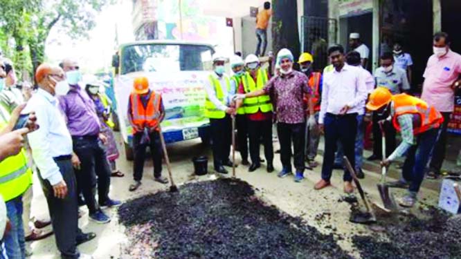 Madaripur's Tekerhat UNO Anisuzzaman inaugurates the 'Rural Road Maintenance Month October-2020' through repairing work of a local road on Thursday.