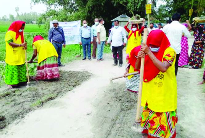 Saju Ahmed, Vice-Charman of Gangachara upazila and Upazila Engineer AZM Ahsan Ullah inspect a local road repair work on Thursday marking 'Rural Road Maintenance Month-October 2020.