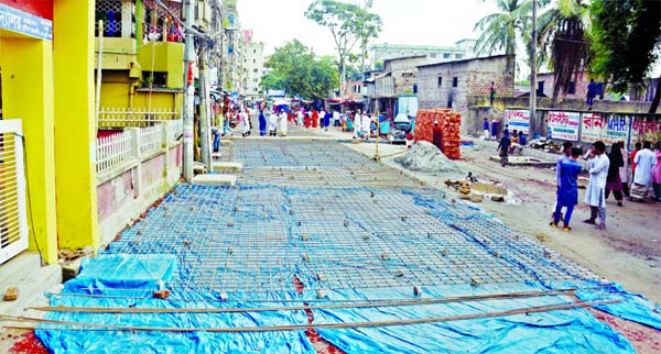 Much to the respite of residents, the Dhaka South City Corporation has started repair works of the capital's Maniknagar Road, which was battered for years. This photo taken on Friday shows rod-binding work is on at the road construction site before pour