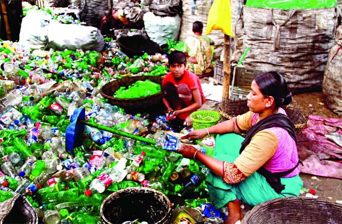 Amena Khatun worked as a domestic help in many households for a long time. But the outbreak of the Coronavirus cut off her source of income. Now, she spends her days stripping labels off plastic bottles littered on the streets at Islambagh area in the cap
