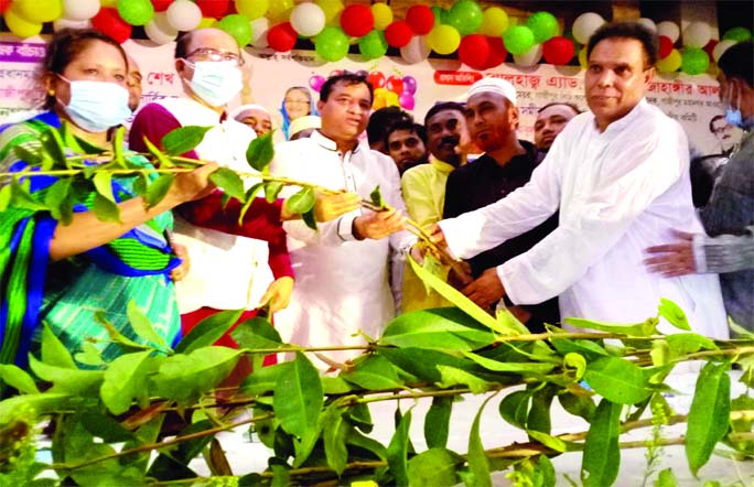 Gazipur City Corporation Mayor Jahangir Alam distributes saplings among local people at a function held at the Sagor-Saikat Convention Centre in the city on Saturday, organized by City Krishok League.