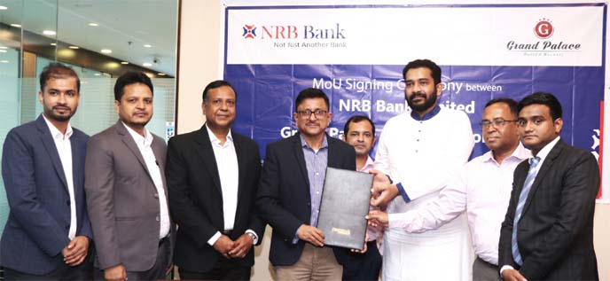 Mamoon Mahmood Shah, Managing Director and CEO (CC) of NRB Bank Limited and Shamsul Alam Pantho, Director, Grand Palace Hotel & Resorts Limited, exchanging documents after signing an agreement at the bank's head office in the city on Sunday. Under the de