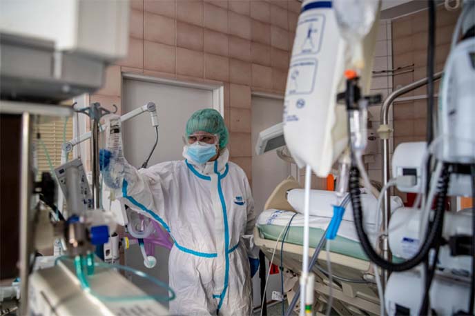 A healthcare worker cares for a COVID-19 patient in an ICU at Na Bulovce hospital in Prague, Czech Republic.