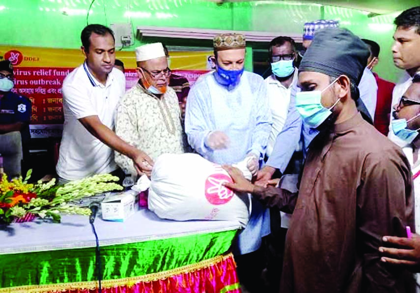 Executive Engineer of Cumilla LGED Khondoker Asaduzzaman, Chauddagram UNO Masud Rana, Upazila Engineer Sumon Talukder and other officials pose for a photograph at the inaugural ceremony of Rural Road Maintenance Month October- 2020 on Mirshanni Bazar Roa