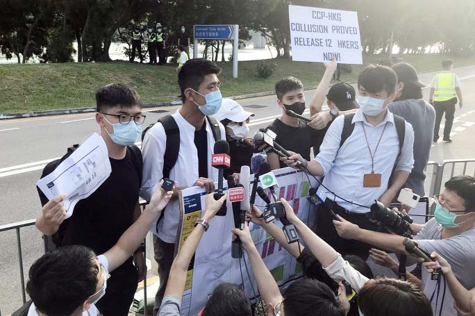 Pro-democracy activists Joshua Wong, Owen Chow and family members of twelve Hong Kong activists arrested as they reportedly sailed to Taiwan for political asylum, speak to media after a protest outside the headquarters of Government Flying Service (GFS),