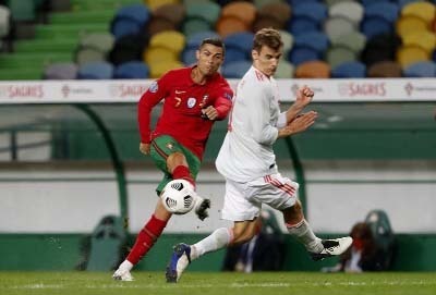Portugal's Cristiano Ronaldo (left) gets in a shot during the international friendly soccer match against Spain at the Jose Alvalade stadium in Lisbon on Wednesday.