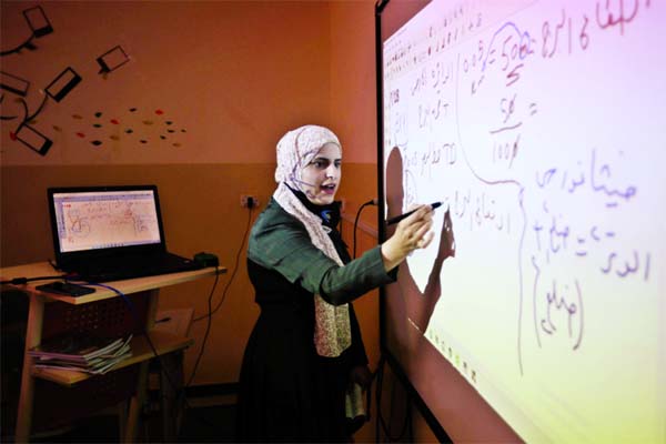 A private school teacher gives an online lesson to students receiving distance education in Amman, Jordan.