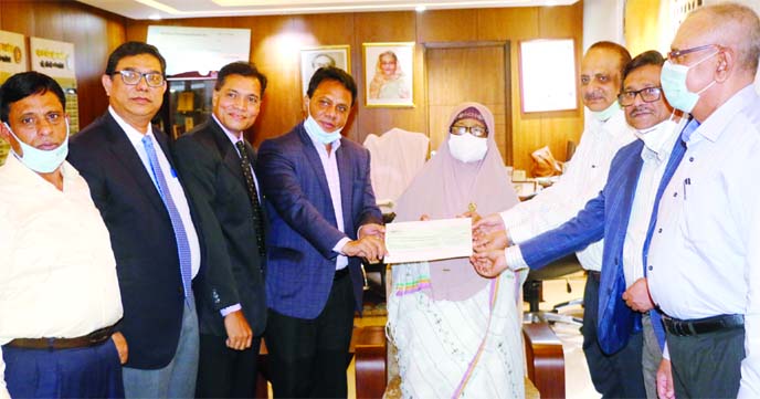K M Ali Azam, Secretary of the Industries Ministry and Chairman of Karnaphuli Fertilizer Company Limited (KAFCO), handing over a cheque worth Tk55,760,000 to Begum Monnujan Sufian, State Minister for Labour and Employment, at her office on Wednesday as pa