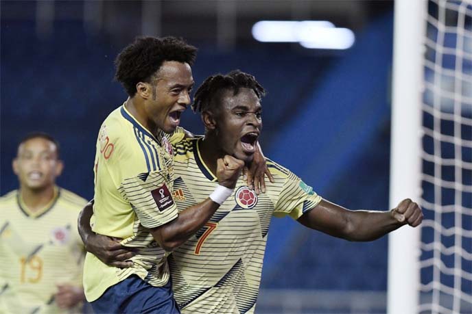 Zapata (right) celebrates with Juan Cuadrado after firing Colombia into an early advantage against Venezuela in Barranquilla, Colombia on Friday.