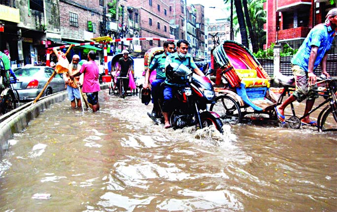 A road in capitalâ€™s Anandabazar area goes under water on Monday after a brief rain due to cityâ€™s poor drainage system.