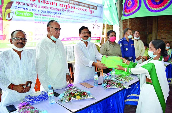 Monoranjan Shil, MP, hands over gifts the teachers on the occasion of Durga Puja ceremony held at the Peerganj College Bazar temple premises on Tuesday.
