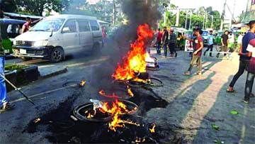 Agitators burn tyres on the street in Sylhet on Tuesday protesting death of a youth in police custody